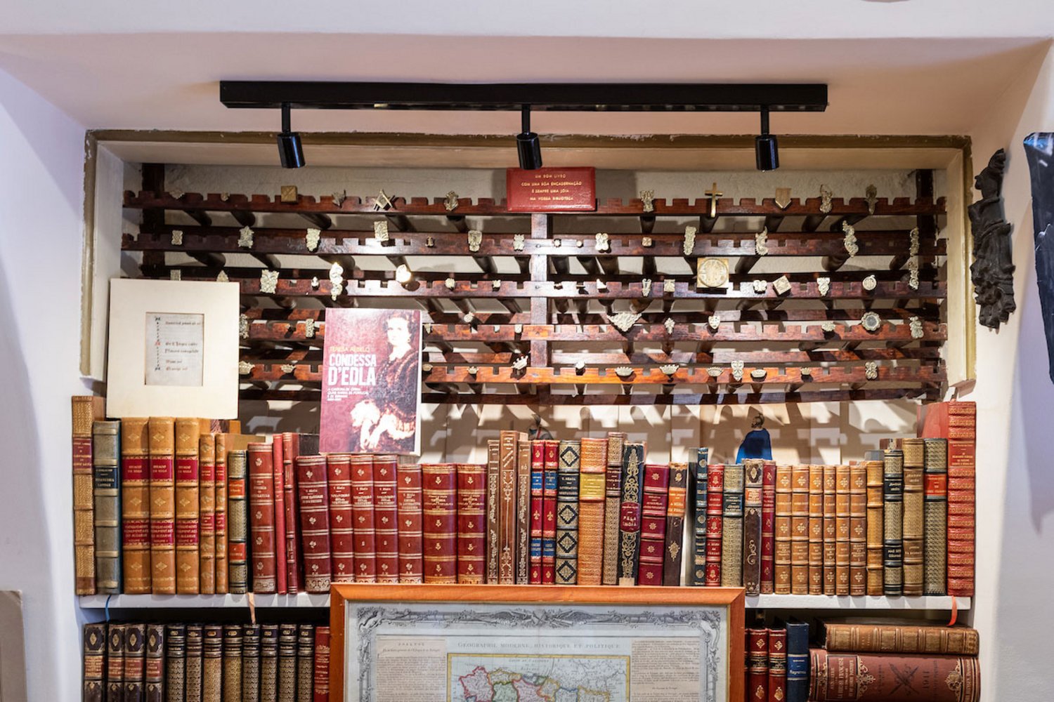 Edições raras e, ao fundo, ferros de dourar encadernações.